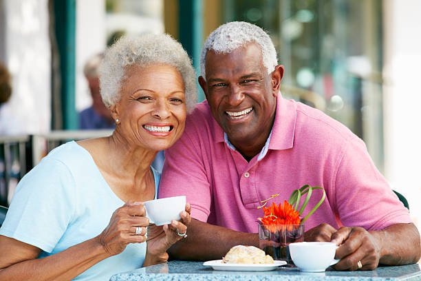 Senior Couple Enjoying Snack At Outdoor Caf